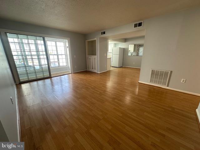 110 Prosperity Avenue Southeast, Unit D Leesburg, VA 20175 - Photo 3 of 25 wooden floor in an empty room with a window