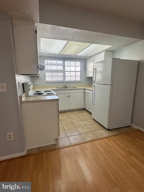 110 Prosperity Avenue Southeast, Unit D Leesburg, VA 20175 - Photo 7 of 25 a kitchen with a sink a refrigerator and window