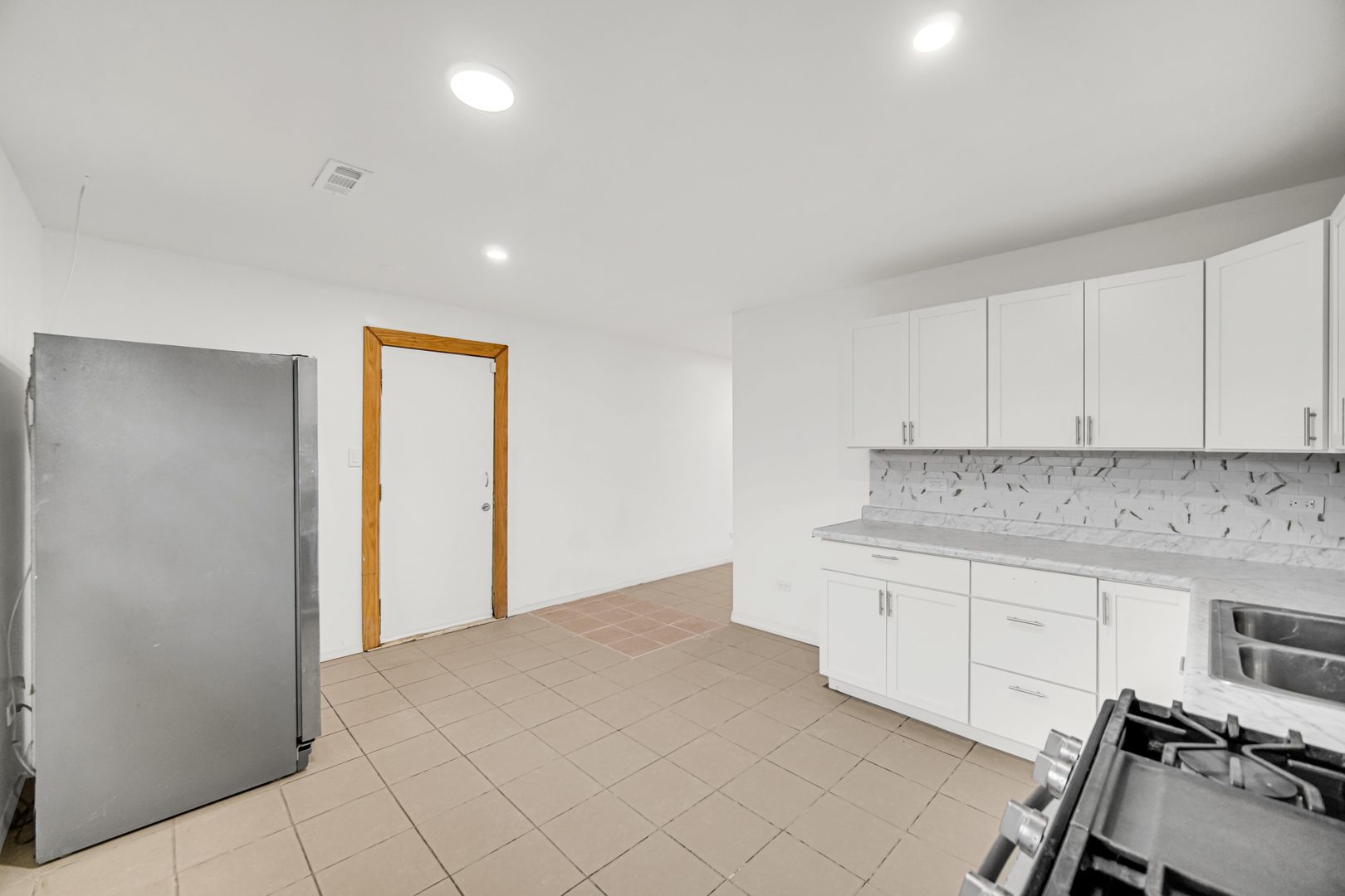 341 Boston Street North Chicago Heights, IL 60411 - Photo 5 of 13 a kitchen with granite countertop white cabinets and white appliances
