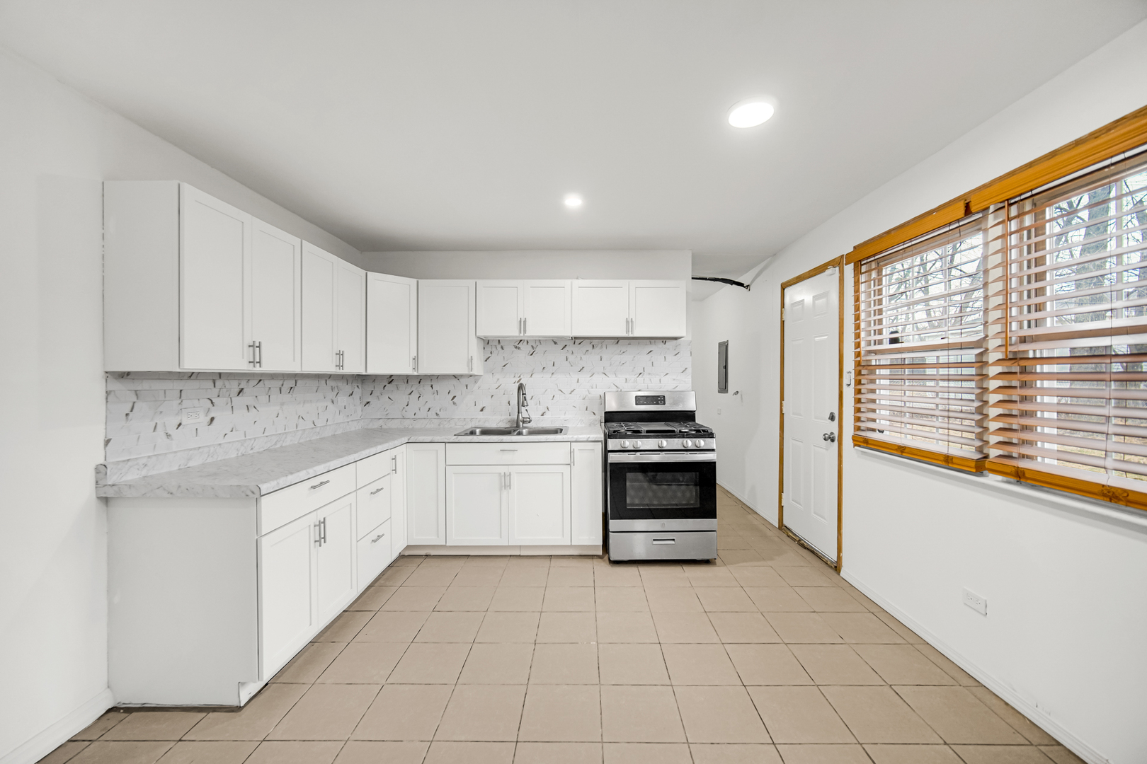 341 Boston Street North Chicago Heights, IL 60411 - Photo 6 of 13 a kitchen with stainless steel appliances granite countertop a stove a sink and white cabinets