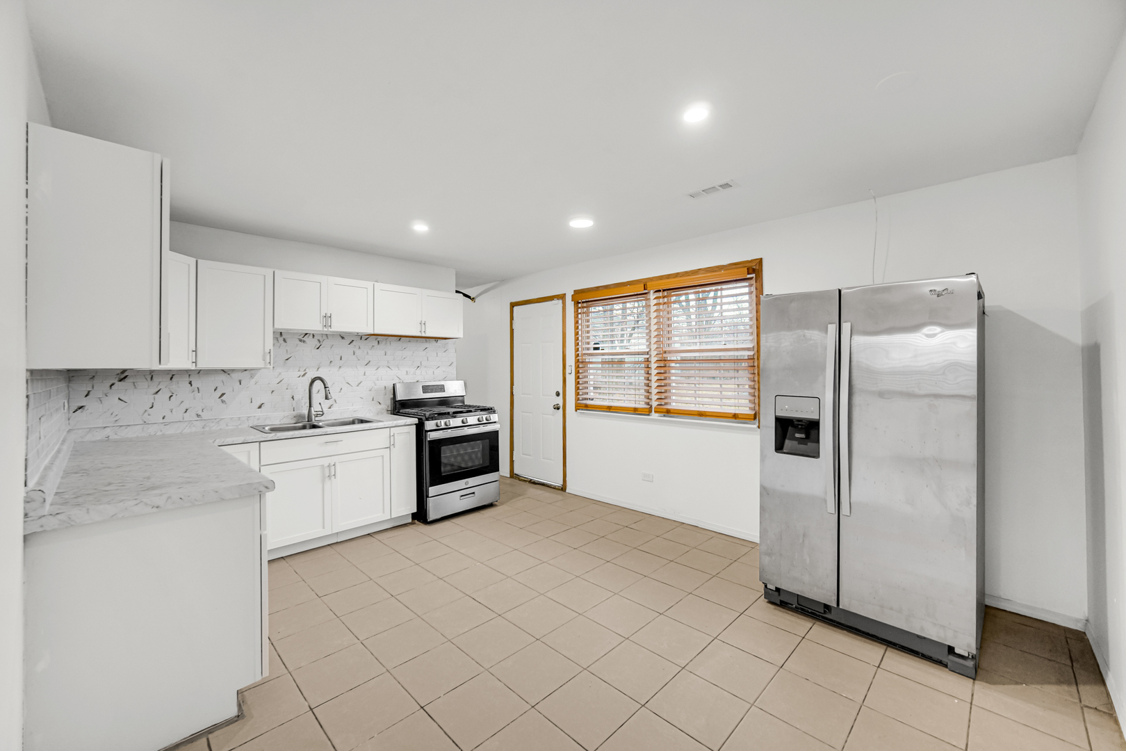 341 Boston Street North Chicago Heights, IL 60411 - Photo 7 of 13 a open kitchen with stainless steel appliances granite countertop a refrigerator and a sink