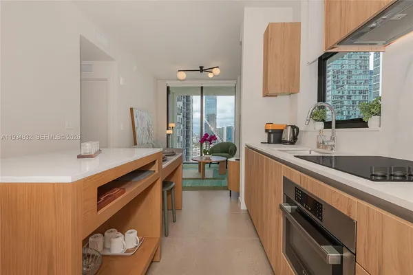 a kitchen with a sink stove and cabinets