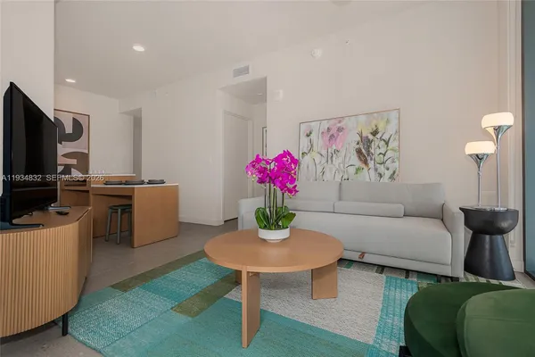 a living room with furniture and a flat screen tv