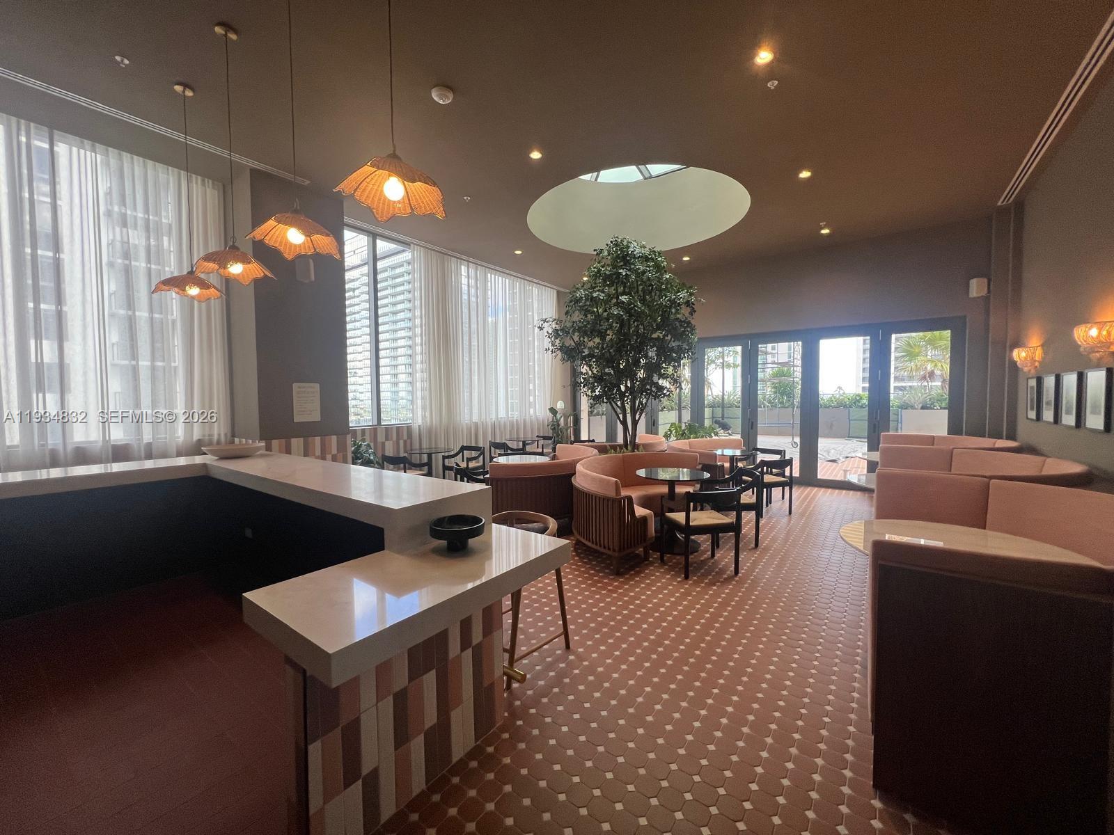 11 Northeast 6th Street, Unit 2709 Miami, FL 33132 - Photo 2 of 39 a view of a dining room with furniture and chandelier