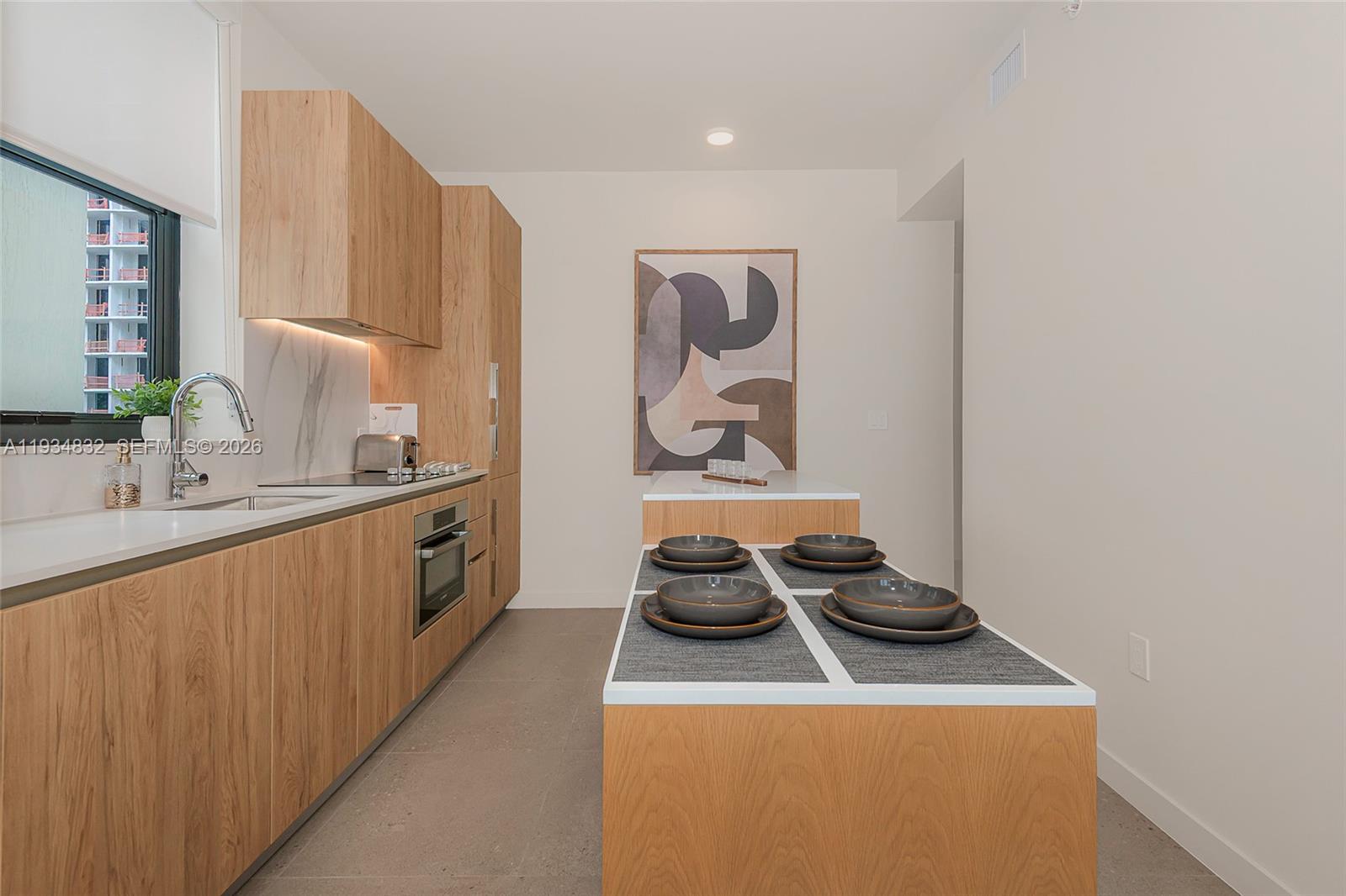 11 Northeast 6th Street, Unit 2709 Miami, FL 33132 - Photo 23 of 39 a kitchen with a stove and a sink