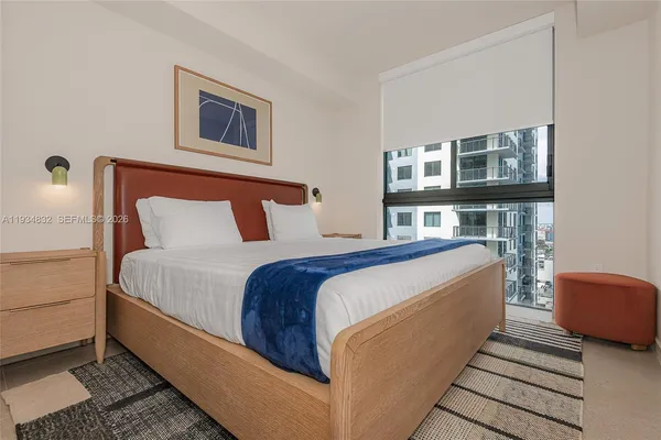 a bedroom with bed and wooden floor