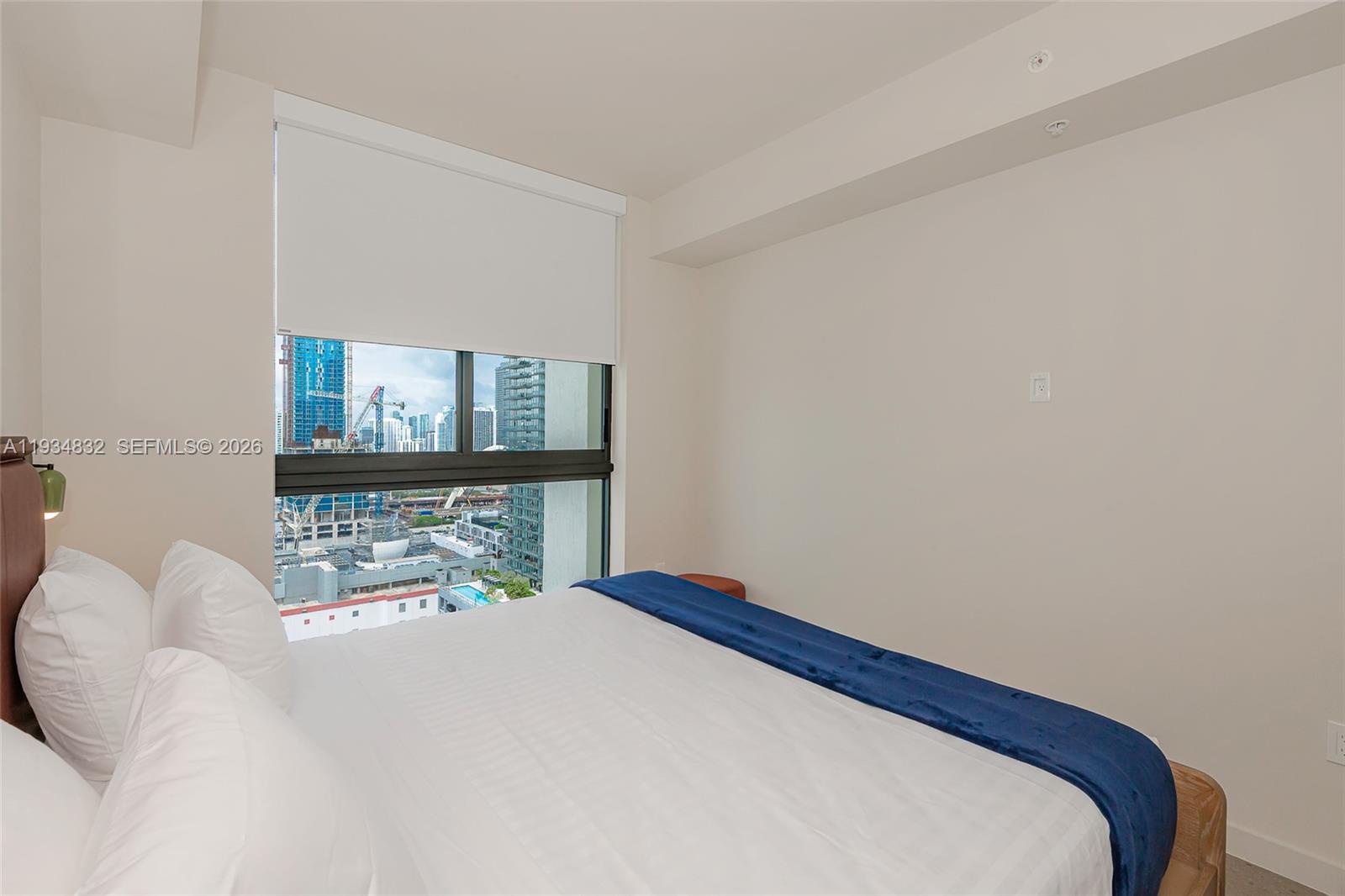 11 Northeast 6th Street, Unit 2709 Miami, FL 33132 - Photo 25 of 39 a bedroom with a bed and a window