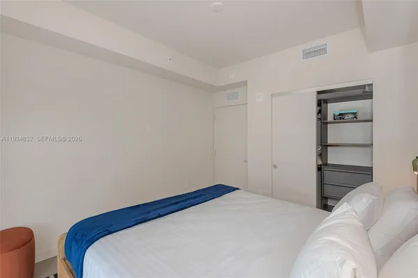 a bedroom with a bed and a chair
