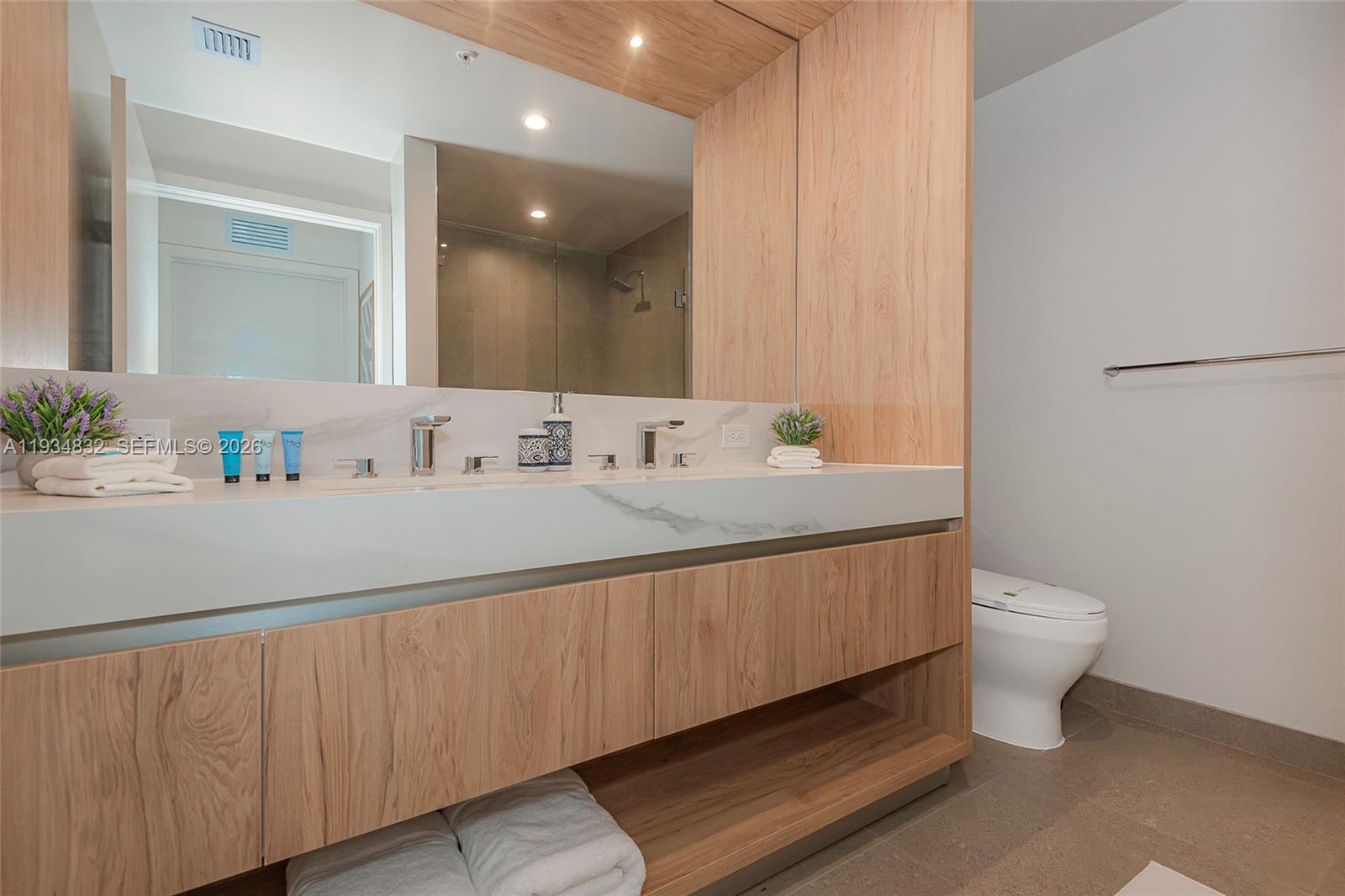 11 Northeast 6th Street, Unit 2709 Miami, FL 33132 - Photo 28 of 39 a bathroom with a sink and a toilet