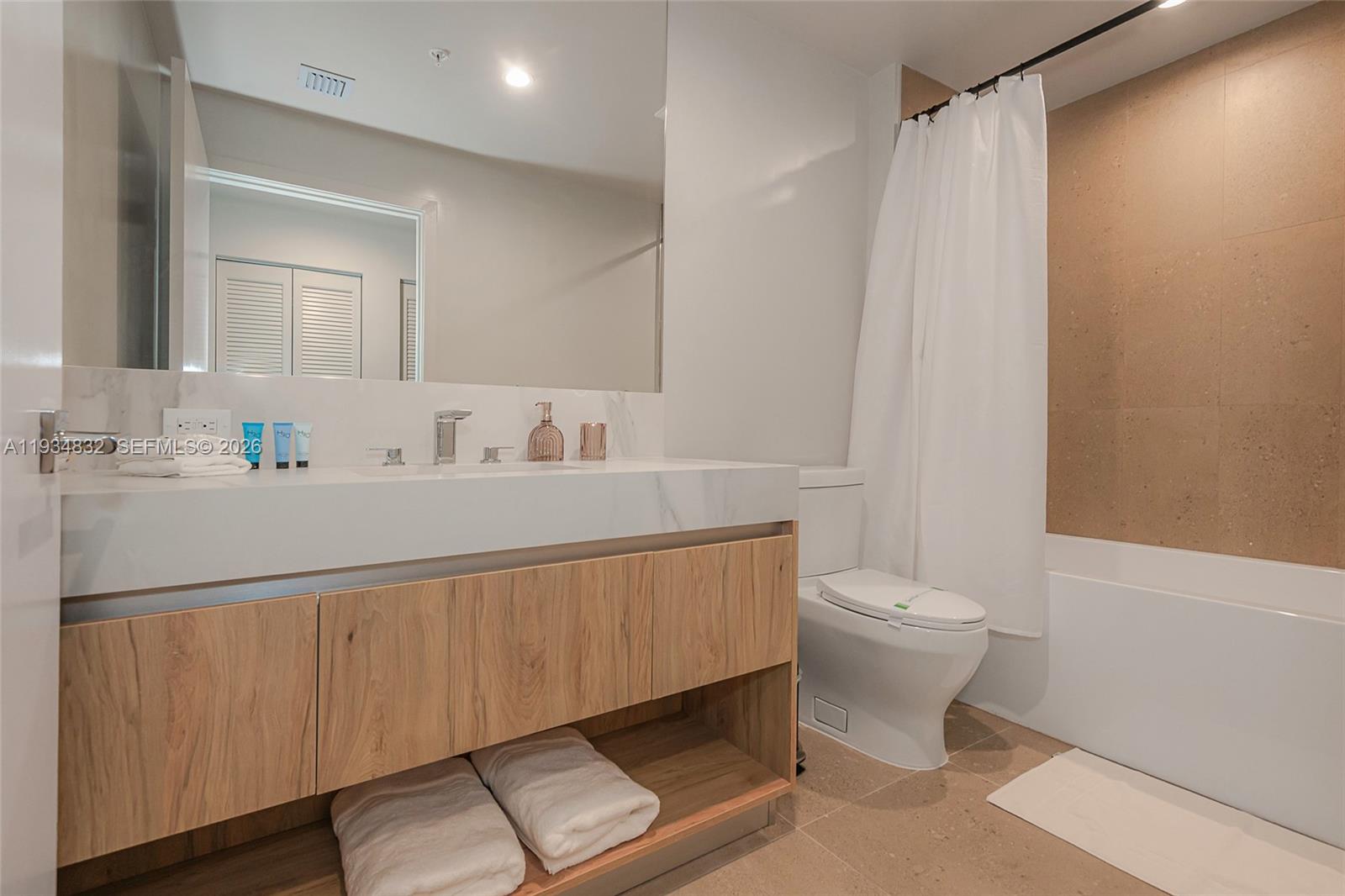 11 Northeast 6th Street, Unit 2709 Miami, FL 33132 - Photo 33 of 39 a bathroom with a sink a toilet and shower