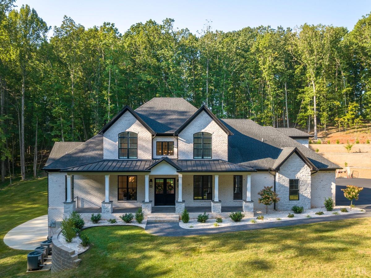 a front view of house with yard barbeque and outdoor seating