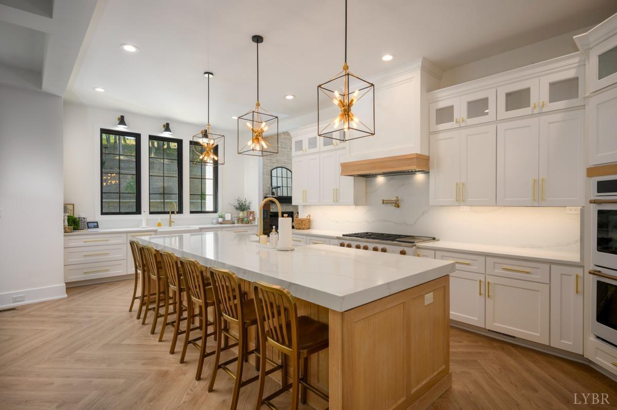 12175 Forest Road Forest, VA 24551 - Photo 11 of 75 a kitchen with stainless steel appliances granite countertop a stove a sink a oven a dining table and chairs