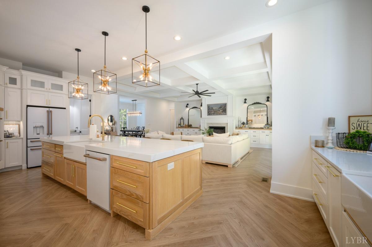 12175 Forest Road Forest, VA 24551 - Photo 17 of 75 a large white kitchen with kitchen island a stove a sink a center island and wooden floor