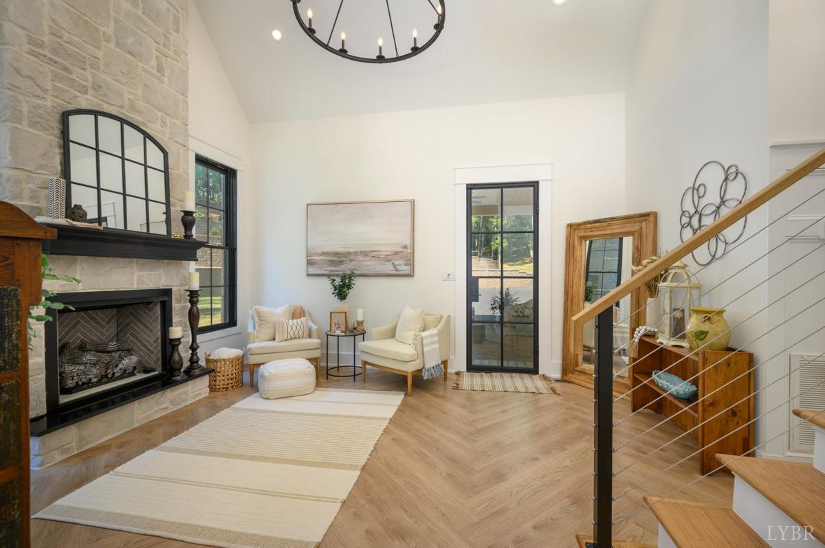 12175 Forest Road Forest, VA 24551 - Photo 32 of 75 a living room with furniture a fireplace and a flat screen tv