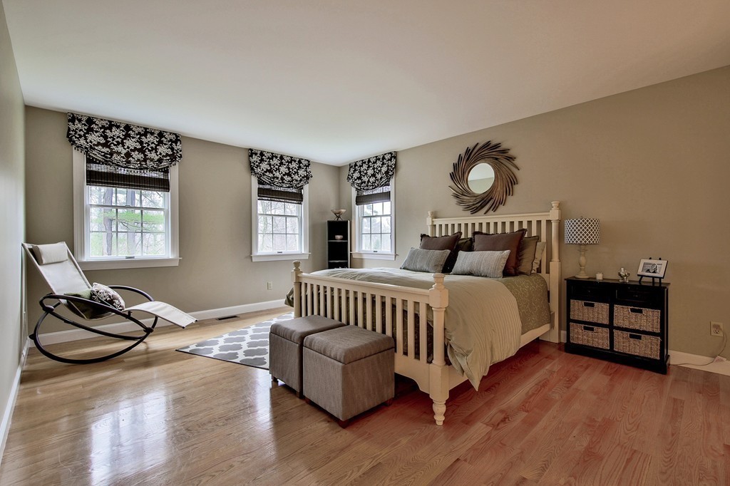 25 Chandler Road Boxford, MA 01921 - Photo 22 of 30 a bedroom with a bed and wooden floor