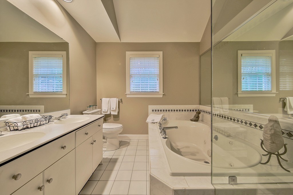 25 Chandler Road Boxford, MA 01921 - Photo 23 of 30 a bathroom with a granite countertop sink a mirror and a bathtub