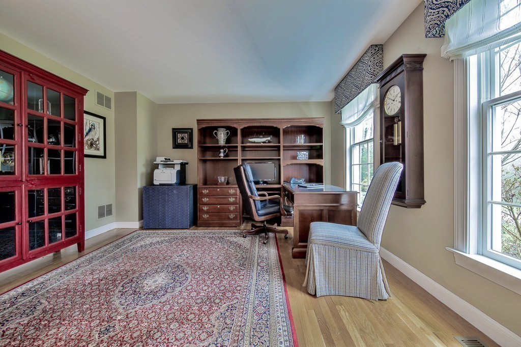 25 Chandler Road Boxford, MA 01921 - Photo 4 of 30 a view of a livingroom with furniture and a bookshelf