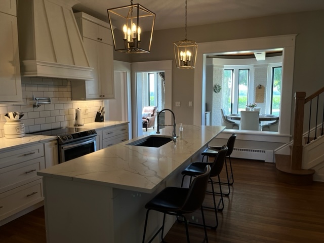 14676 East Twombly Road Rochelle, IL 61068 - Photo 22 of 63 a kitchen with stainless steel appliances granite countertop a sink dishwasher a stove a refrigerator a dining table and chairs with wooden floor