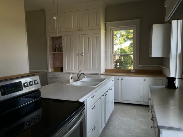 14676 East Twombly Road Rochelle, IL 61068 - Photo 29 of 63 a kitchen with a sink stove and cabinets