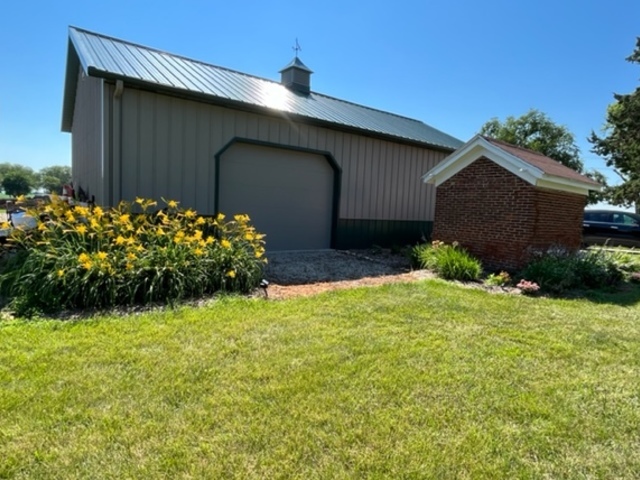 14676 East Twombly Road Rochelle, IL 61068 - Photo 56 of 63 a house is sitting in middle of the green field
