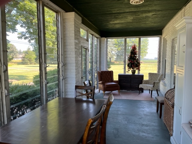 14676 East Twombly Road Rochelle, IL 61068 - Photo 9 of 63 a living room with patio furniture and a floor to ceiling window