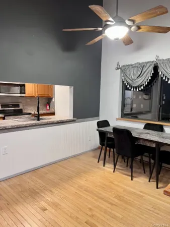a view of a dining room with furniture and wooden floor