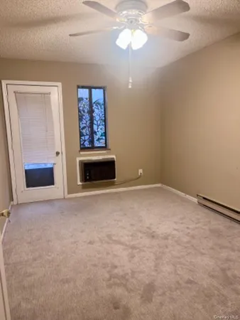 en empty room with windows and fireplace