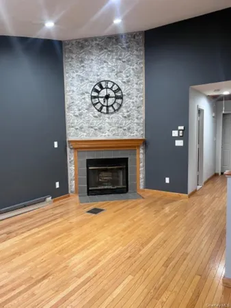 a view of an empty room with a fireplace and a fireplace