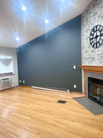 a view of empty room with a fireplace