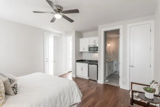 a spacious bedroom with a bed and a chandelier