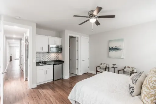 a bed room with a bed and ceiling fan