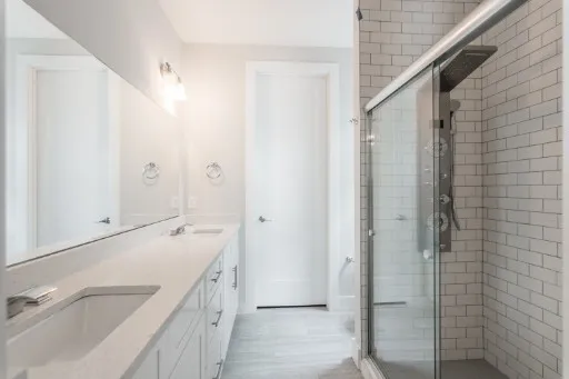 a bathroom with a double vanity sink and mirror