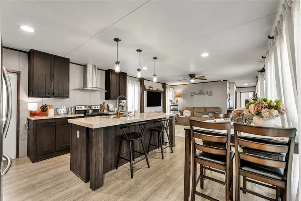 a kitchen with kitchen island a sink stove and refrigerator