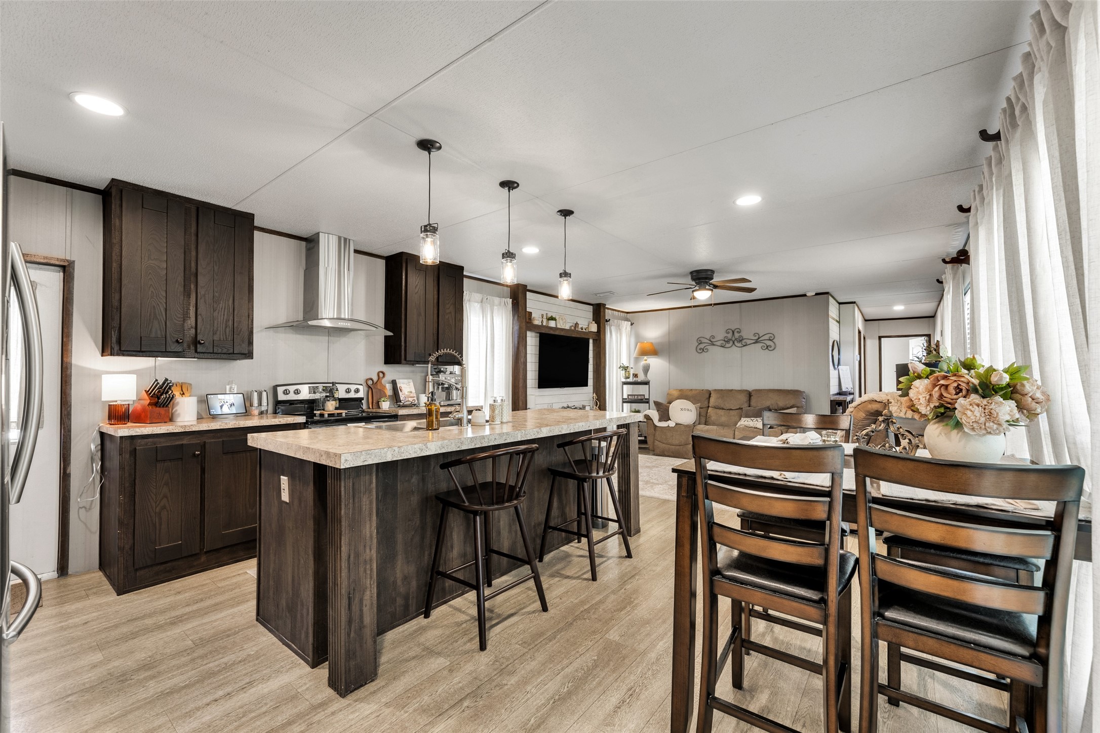 a kitchen with kitchen island a sink stove and refrigerator