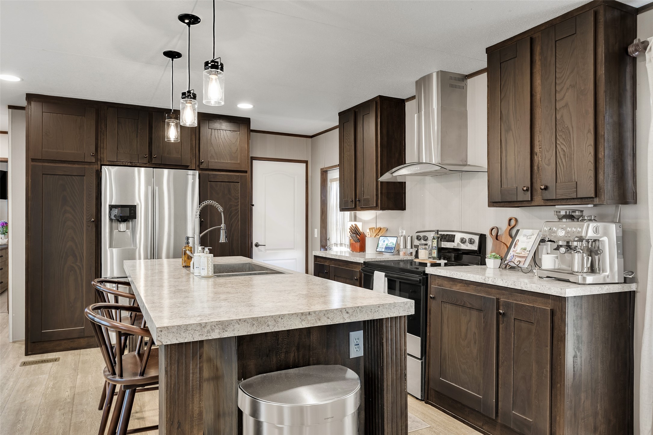 3133 Henderson Road Navasota, TX 77868 - Photo 10 of 26 a kitchen with a table chairs refrigerator and microwave