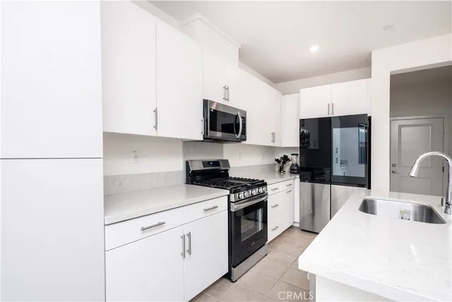 a kitchen with a sink a stove and refrigerator