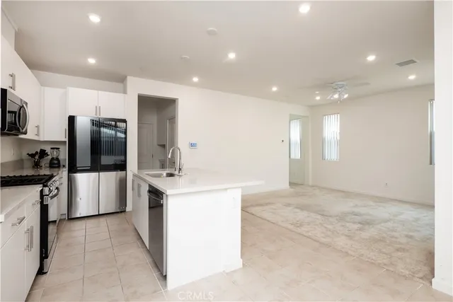 a large kitchen with cabinets and stainless steel appliances