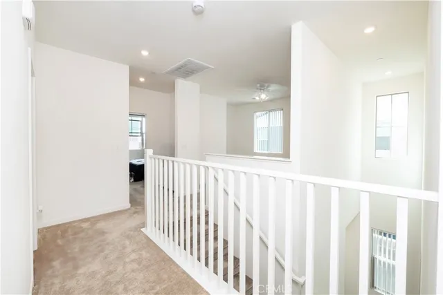 a view of a hallway with windows