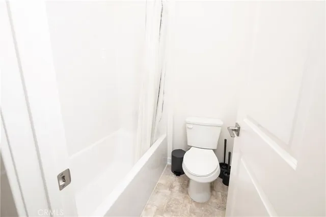 a white toilet sitting next to a white sink