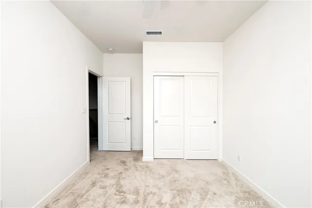 a view of a room with a refrigerator