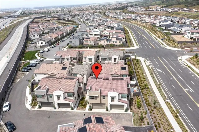 an aerial view of residential houses with outdoor space