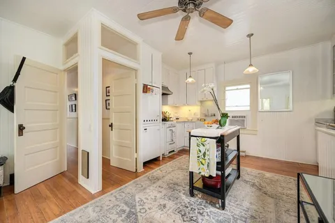 a kitchen with stainless steel appliances granite countertop a sink a stove and a refrigerator