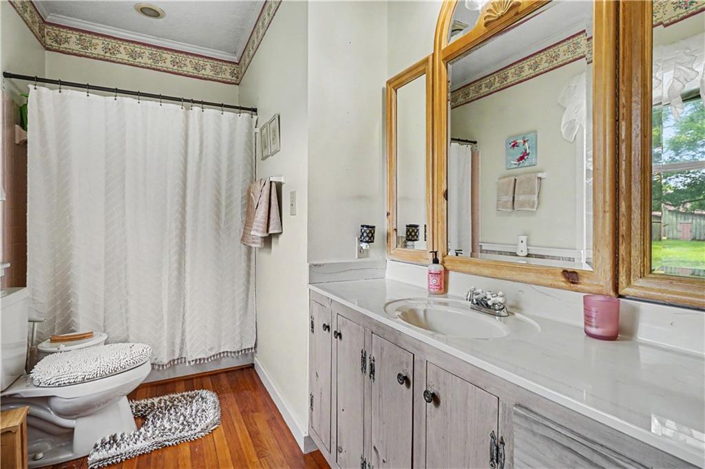 355 Inman Road Hampton, GA 30228 - Photo 24 of 47 a bathroom with a granite countertop sink and a mirror