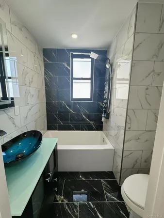 a bathroom with a sink a toilet and bathtub