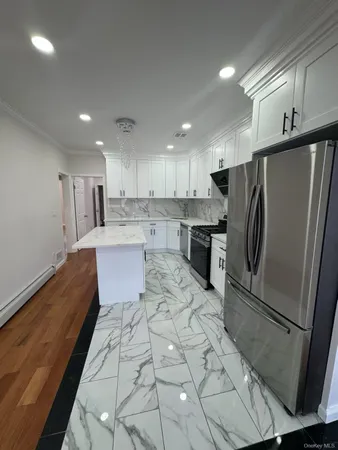 a kitchen with stainless steel appliances a refrigerator sink and microwave