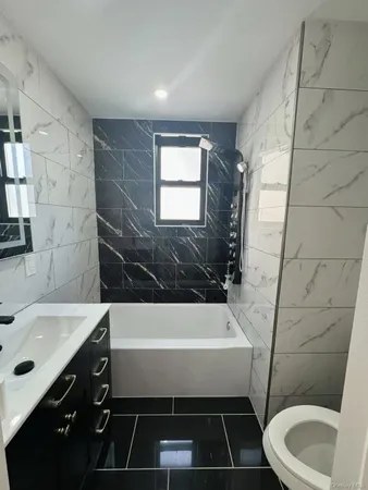 a bathroom with a sink a toilet and bathtub