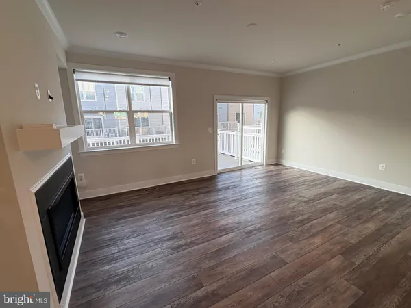 a living room with a fireplace and a flat screen tv