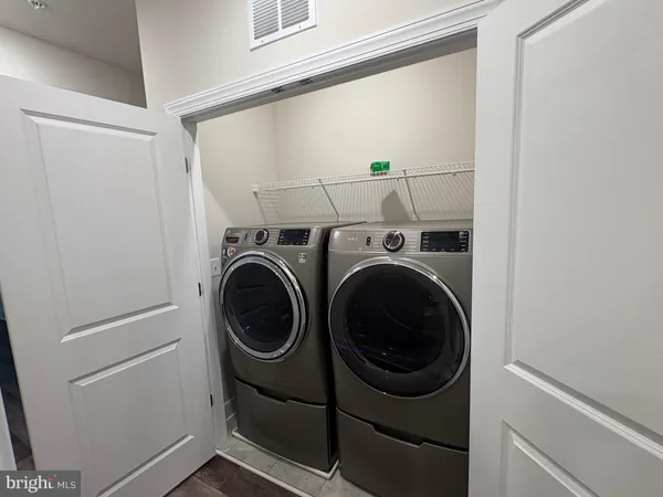 a view of hallway with kitchen outdoor dining table and chair