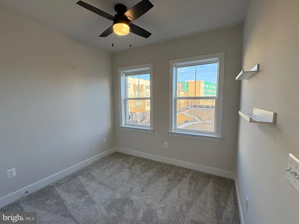 a kitchen with white cabinets and sink