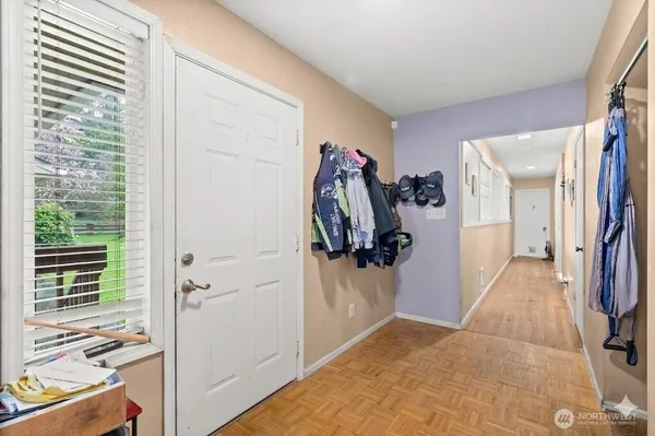 a view of a hallway with closet and a livingroom view